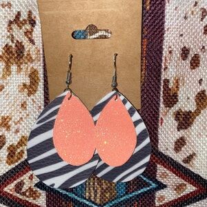 Faux leather earrings . Coral and zebra print . Very light weight . Never worm